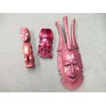 Two wooden masks and an ethnic figure