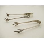 Two pairs of scaled effect and foliate detail silver sugar tongs,