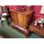 A French style television cabinet of bombe chest form, twin folding doors over base fall-flap,