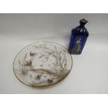 A Dutch blue glass flask and a French clear glass dish decorated in gilt with birds,