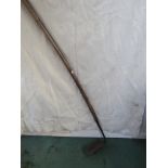 A long handled drainage scoop