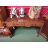 An Edwardian crossbanded mahogany side table the two frieze drawers over square tapering legs,