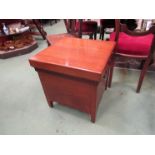 A mahogany shoe box, the hinged seat over a shaped apron and brass swan neck handles,