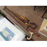 Four assorted walking sticks including ethnic examples