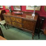 A George V walnut sideboard, the two central drawers flanked by cupboard doors,