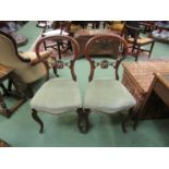 A pair of mid Victorian carved walnut chairs on cabriole fore legs