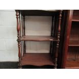 A Victorian mahogany three tier whatnot with turned supports