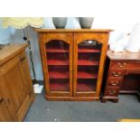 A Victorian burr walnut bookcase, two doors opening to reveal lined shelf space,