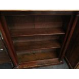 A Victorian mahogany and pine two shelf bookcase with column supports,