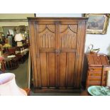 An old charm oak two door wardrobe with linen fold decoration,