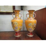 A pair of Japanese twin handled vases, mustard colour ground with blossom design,