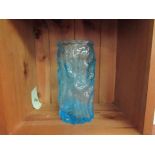 An aqua blue glass vase,