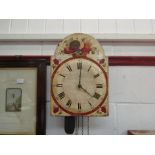 A Victorian wall clock with painted face