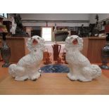 A pair of late Victorian gilt and white Staffordshire dogs, 31cm tall,