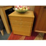 A modern beech finish office file chest of three drawers,