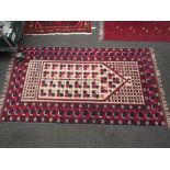 A Middle Eastern wool rug cream ground with red and blue borders and leaf design,