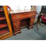An 18th Century and later mahogany kneehole desk, eight drawers and recessed door,