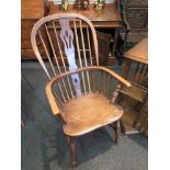 A 19th Century elm seated hoop-back Windsor elbow chair,