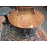 An oak occasional drop-leaf table and a bathroom mirror