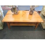 A pine coffee table on shaped legs with under-tier,
