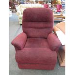 An electric reclining armchair in plum