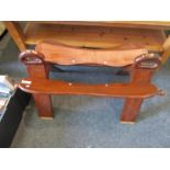 An Eastern hardwood saddle stool with brass inlay