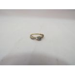 A gold ring with diamond flower centre and diamond set shoulders, stamped 9k, size O,