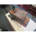 A vintage wall mounted oak cased telephone