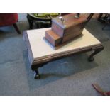 A mahogany claw foot low table with marble top,