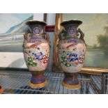 A pair of Oriental enamelled vases with figural scenes,