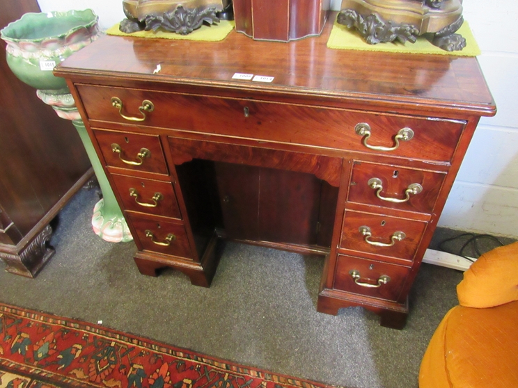 An 18th Century and later mahogany kneehole desk, eight drawers and recessed door,