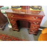 An 18th Century and later mahogany kneehole desk, eight drawers and recessed door,