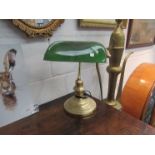 A brass based bankers lamp with green glass shade,