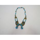 A turquoise coloured bead and gilt metal necklace