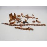 A box of copper coloured jewellery including bangle, brooches,