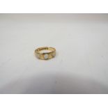 An 18ct gold wedding band set with three opal stones