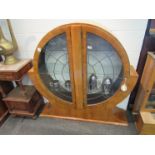 An Art Deco cabinet of rounded form,