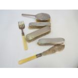 A silver backed four piece dressing table set and a pair of silver bladed fish knives and forks