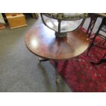 A Regency style mahogany tilt-top tripod wine table on lion paw castors, 51cm tall,