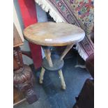 A circular top table supported by deer legs, 48cm diameter,