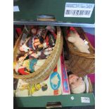 Assorted vintage dolls including a basket of costume dolls together with a wicker crib,