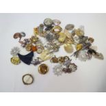 A box of various costume brooches