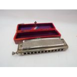 A boxed Hohner Super Chromonica harmonica
