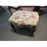 A 1930's walnut coffee table and a needlepoint overstuffed stool,