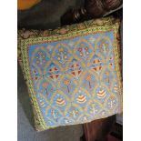 An oversized cushion, one side machine woven Eastern style design,
