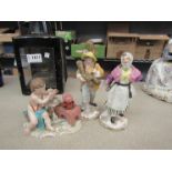 Porcelain figures including cherub and farming couple,