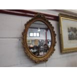 A gilt oval wall mirror,