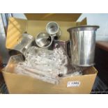 A box containing glassware and plated items including candlesticks and tankards