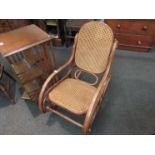 An American cane seated and backed rocking chair