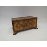 A parquetry inlaid trinket box on ogee bracket feet